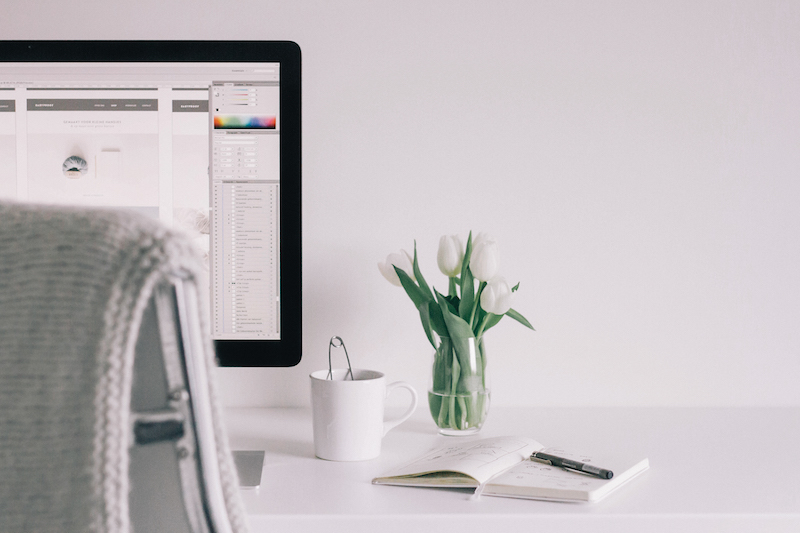 imac on desk with plant