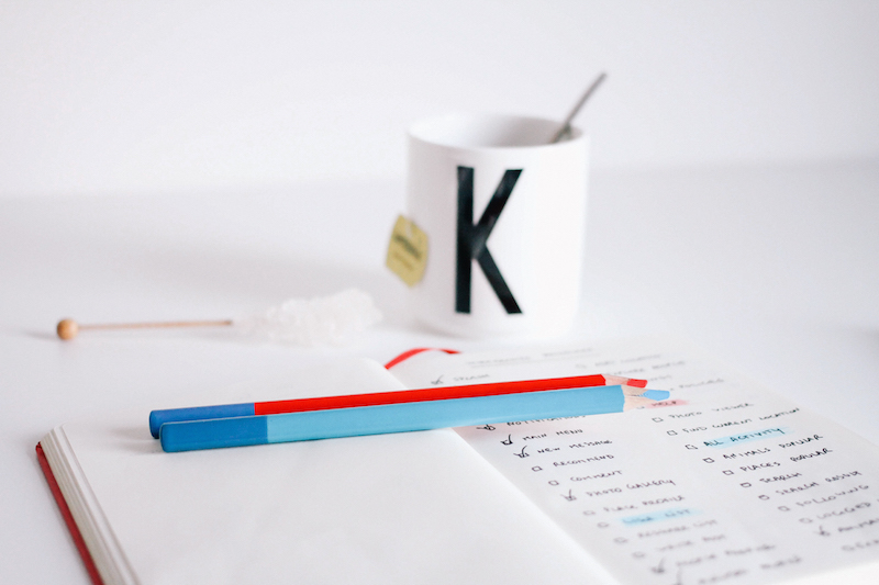 coffee cup with journal and pen