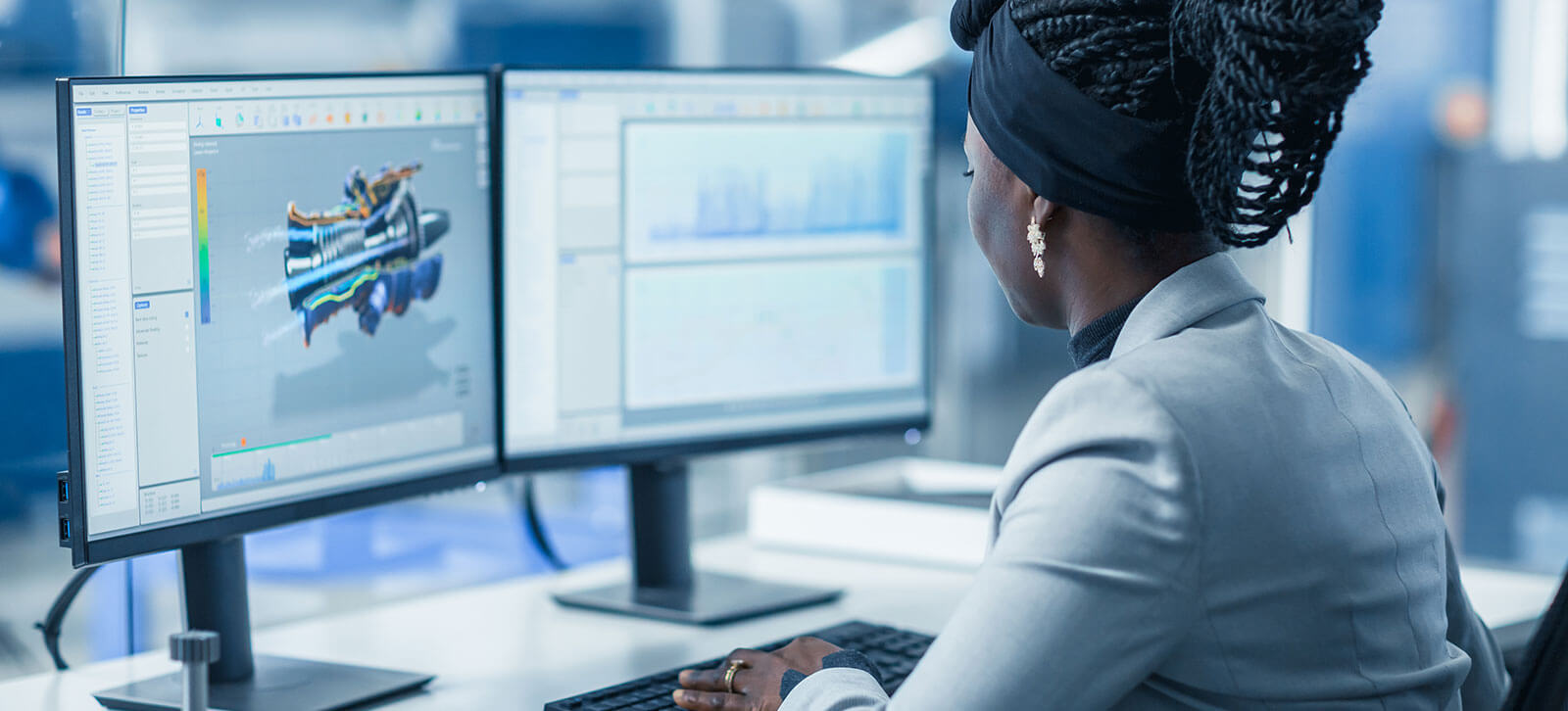 A women looking at a 3D rendering of a product on a monitor