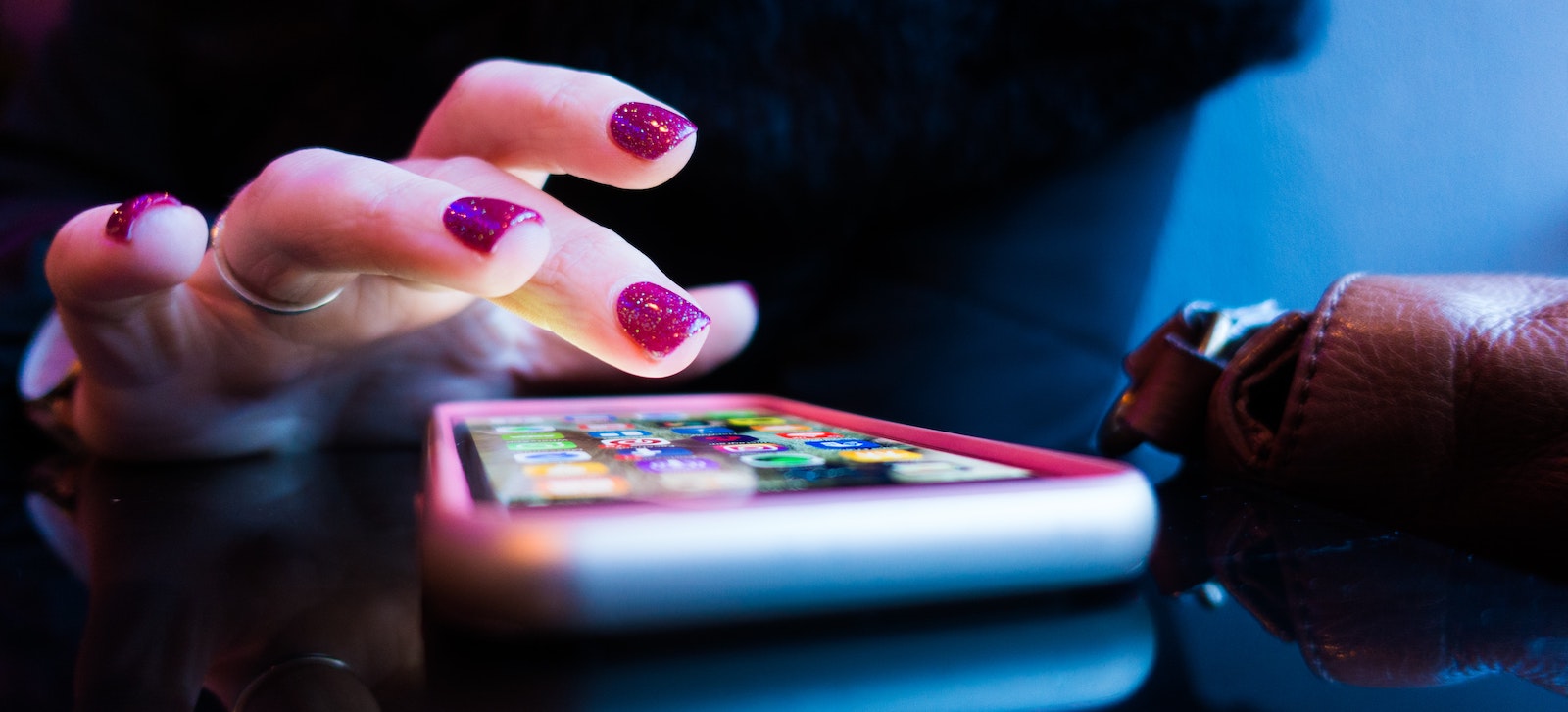 woman scrolling through apps on her phone