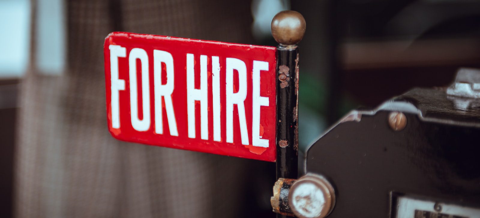 shallow focus photography of red and white for hire signage