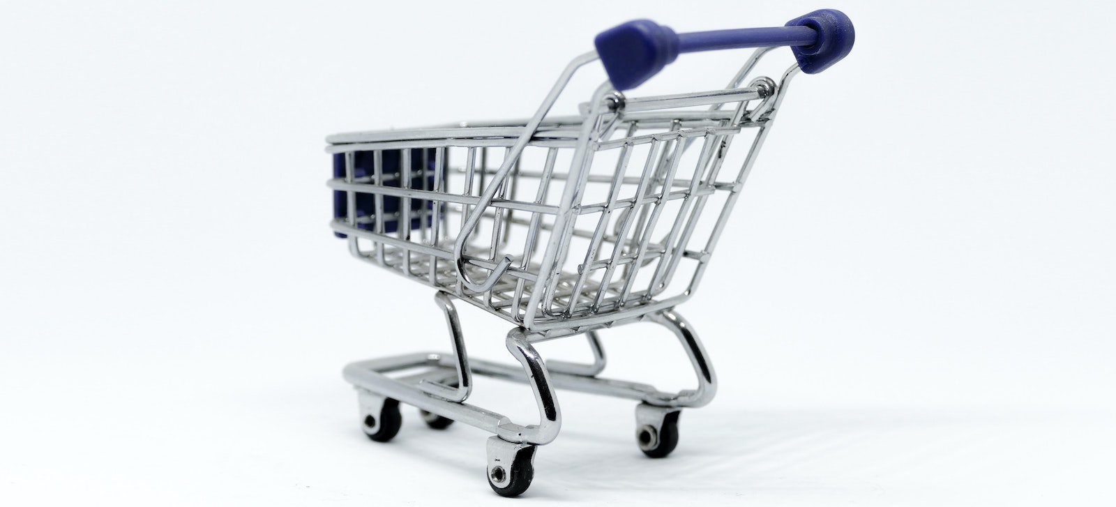 tiny shopping cart across a white background