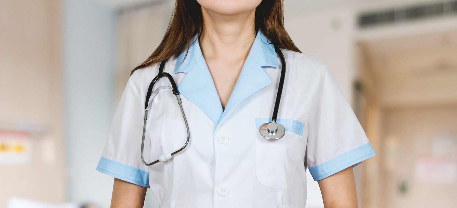 woman in white button up shirt and blue stethoscope