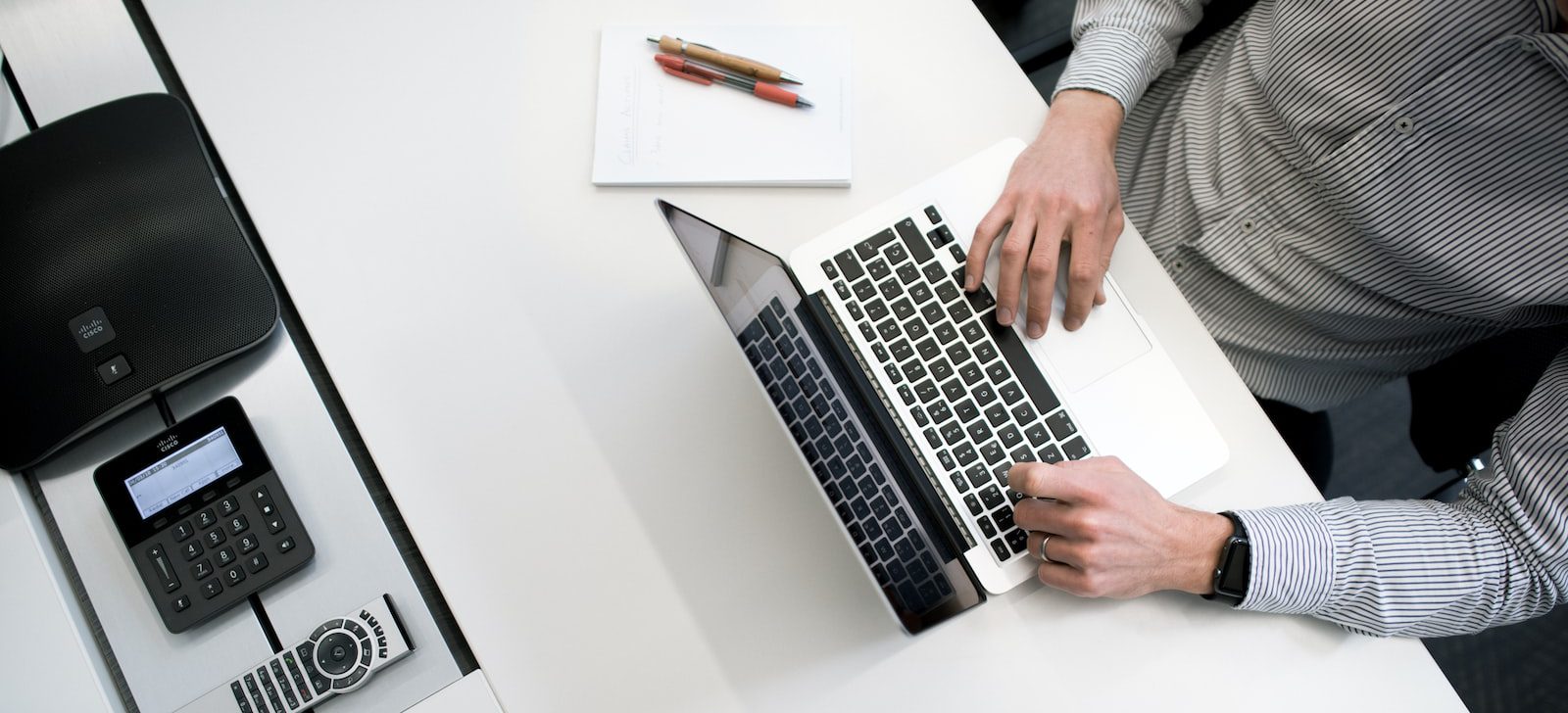 person using laptop on white wooden table