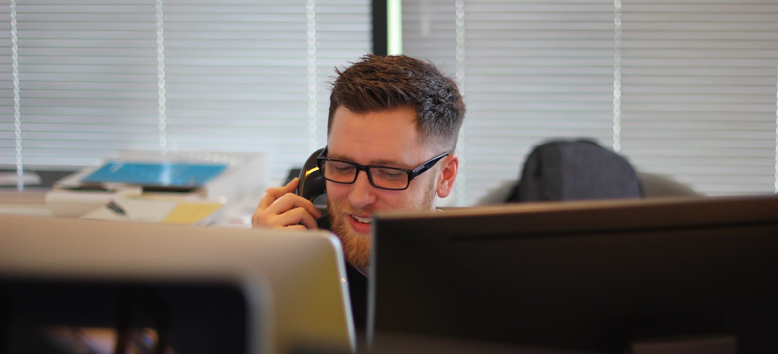 man using IP phone inside room