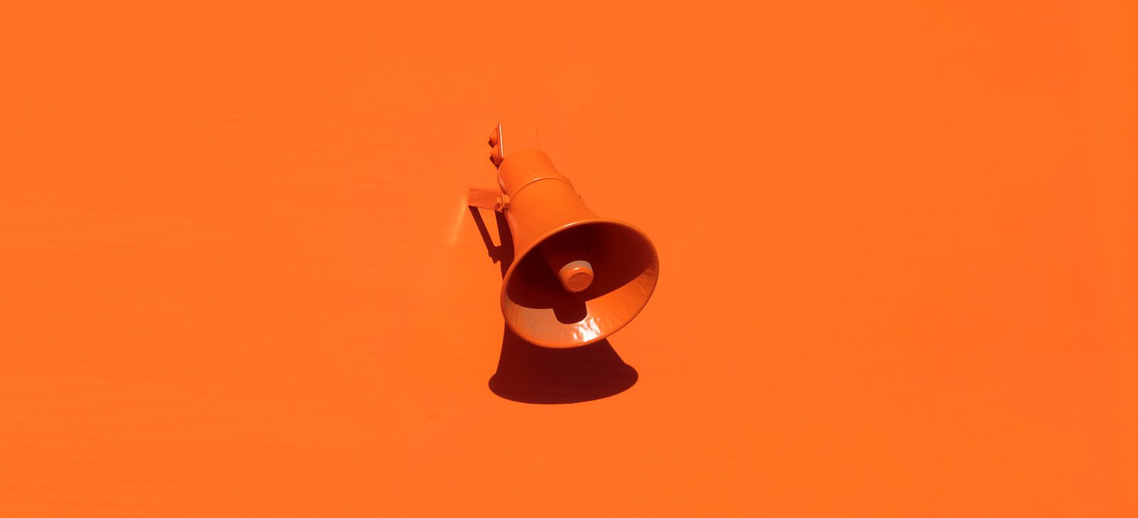 orange megaphone on orange wall