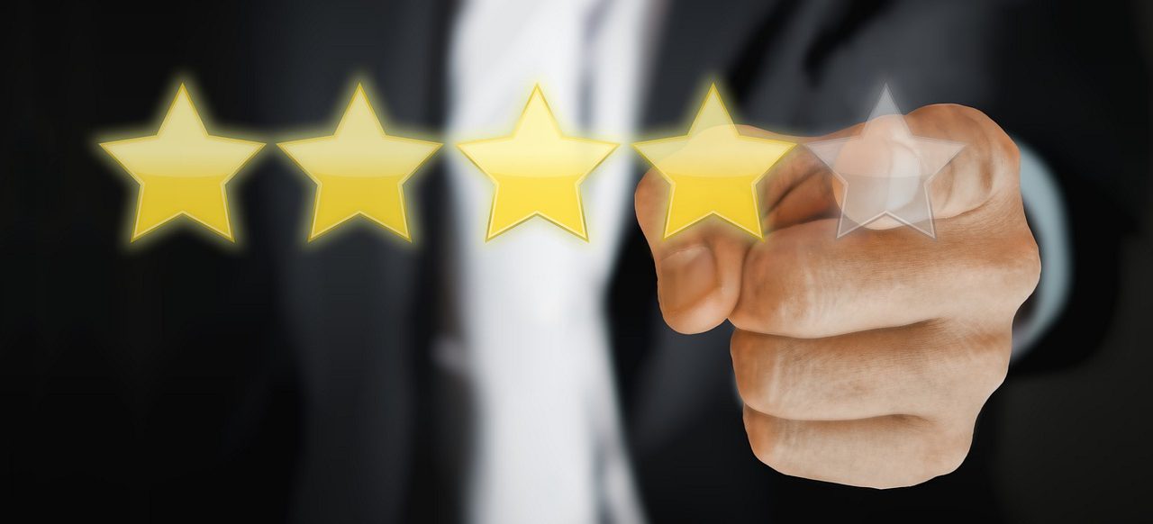 A photo illustration of a hand pointing at a 5-star rating