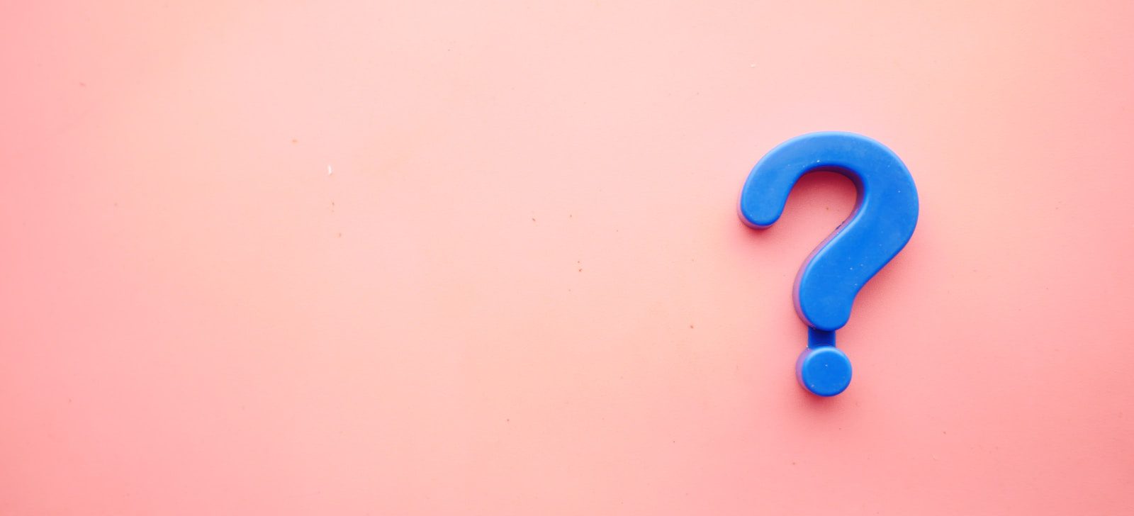 a blue question mark on a pink background